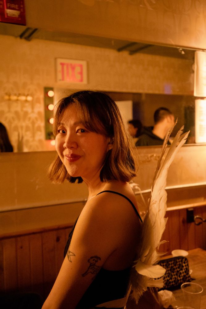 photo of me in angel wings in warm light backstage at baby’s all right