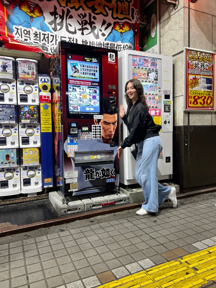A picture of me by the Like A Dragon vending machine in Tokyo 
