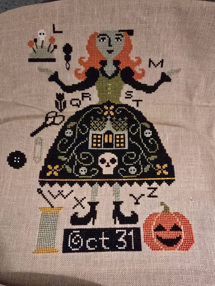 Witchy cross stitch in progress with witch, sewing needle and scissors, Oct 31, and jack o lantern. #crossstitch #stitchsky #craftsky #spooky #halloween