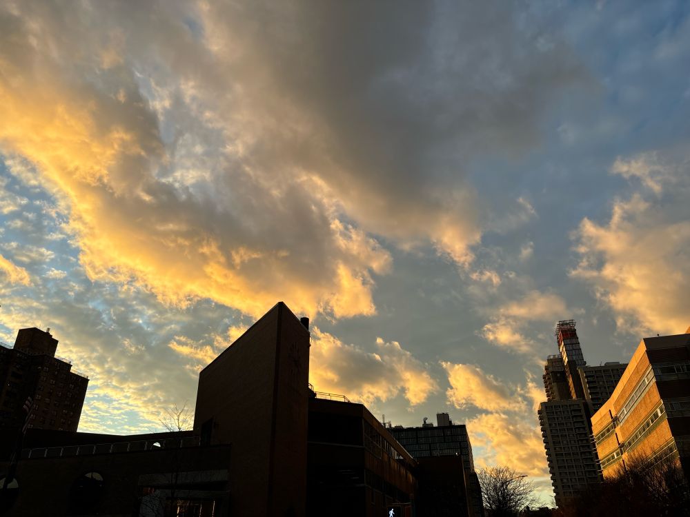 clouds lit with golden late sunlight over brooklyn