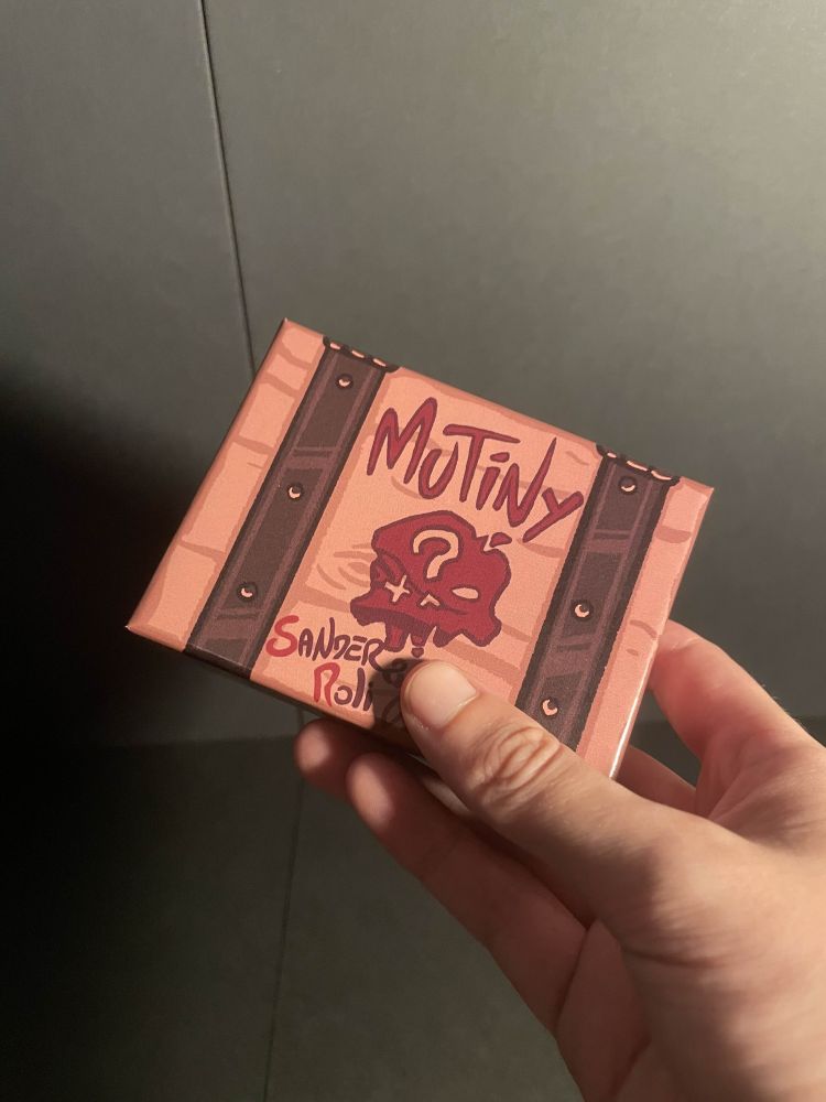 A box with a skull design that looks like a Sea of Thieves ammo crate, and reads: "Mutiny" - Sander Roli & [redacted]