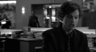 Spencer Reid spinning in his office chair.