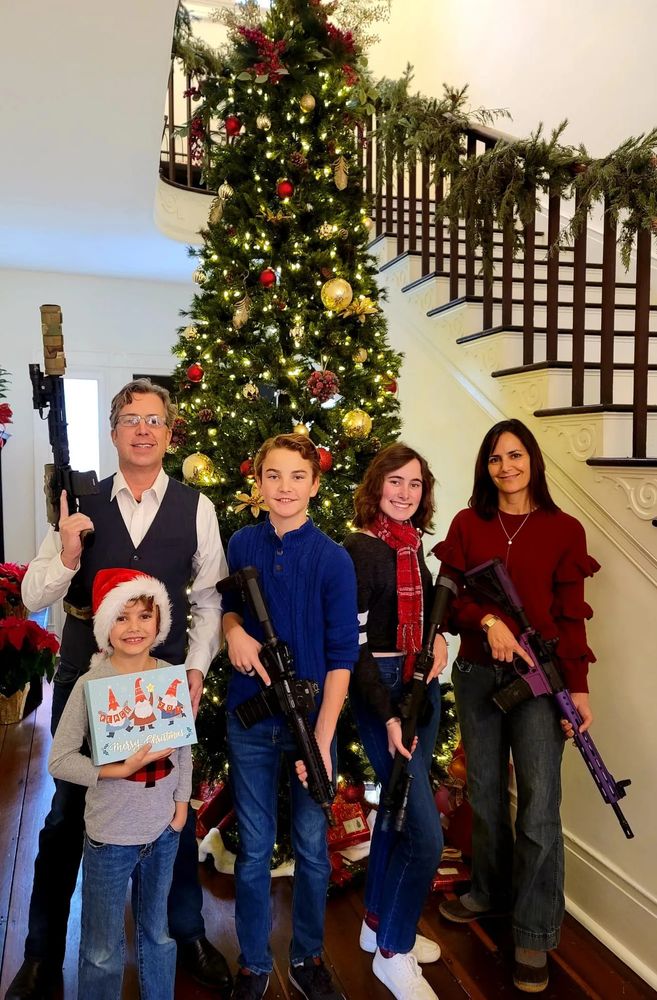 Rep. Andy Ogles (R-TN) and family in a 2021 photo. Andy, his wife, and the oldest two of their three children brandish rifles.
