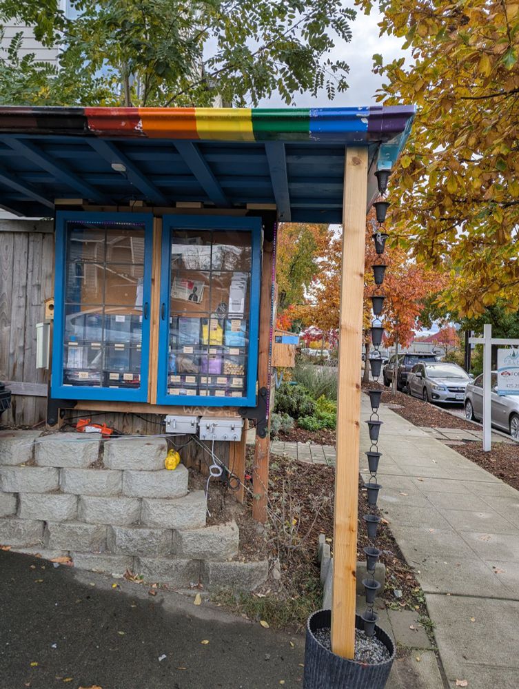 A rainbow striped rain shelter protects a big cabinet with little compartments for everything from socks to condoms to first aid supplies, pens and snacks. 