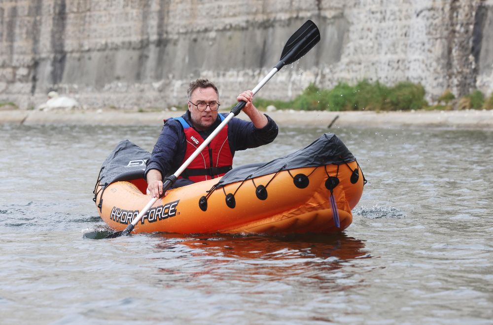 Looking far from comfortable, I attempt to control a kayak.