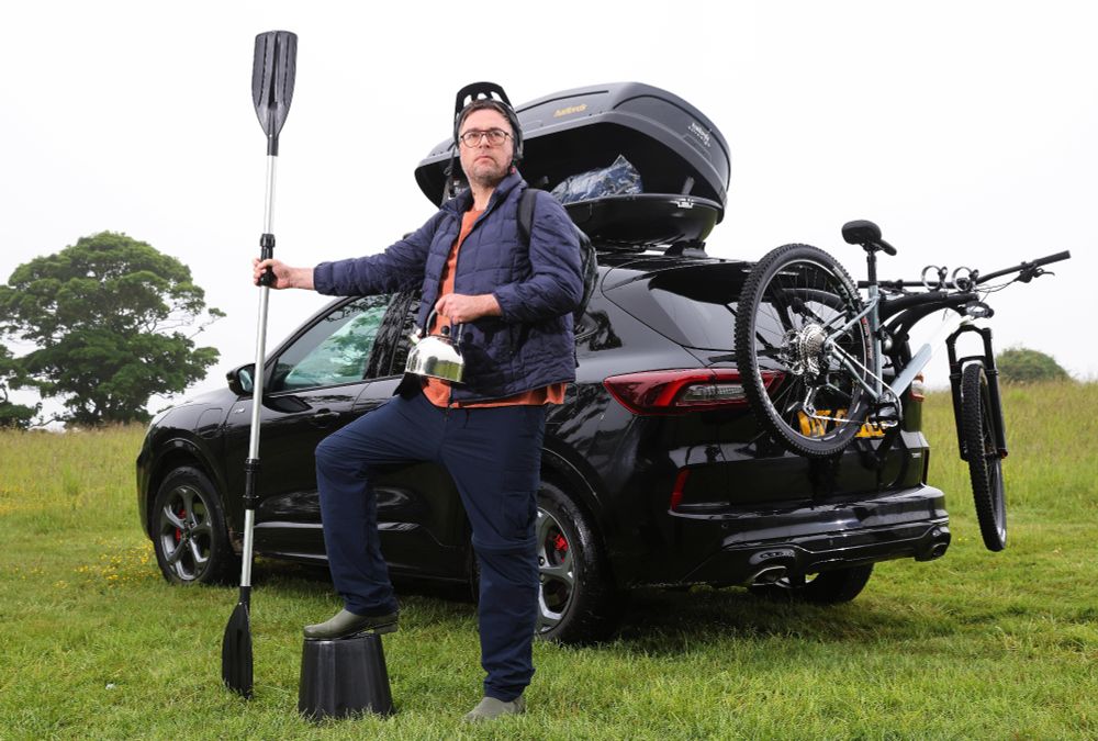 Looking magnificent, like a regal lion, Danny holds a kayak paddle like a royal standard, a crown-like bike helmet that secures his legacy as King of the Road, and for some reason a small kettle. Also not sure why he's got his foot on a plastic bucket.