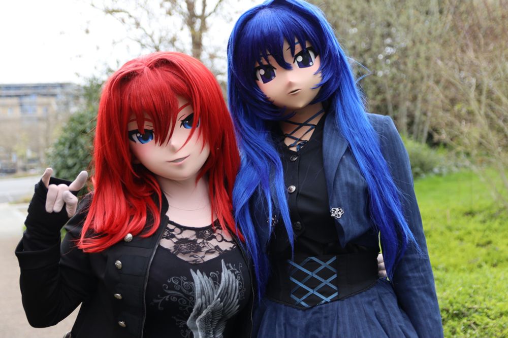 Scarlett holding up the 'devil horns', next to Contrast.