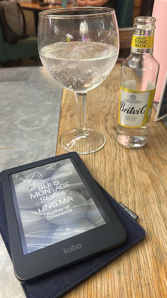 Reading from a Kobo e-reader with a glass of wine