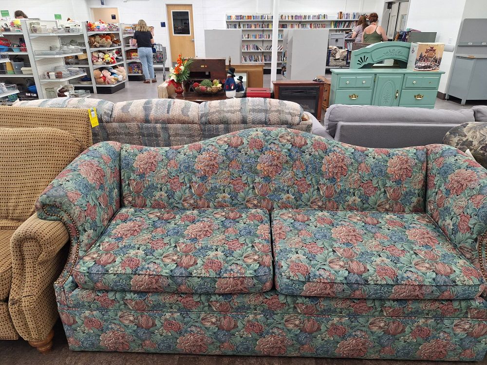 Local Mormon church owned thrift store. A hideous floral print couch is surrounded by other couches. I want this couch so bad. This style of couch was very prominent in meeting house foyers in the 90s and the 2000s. 