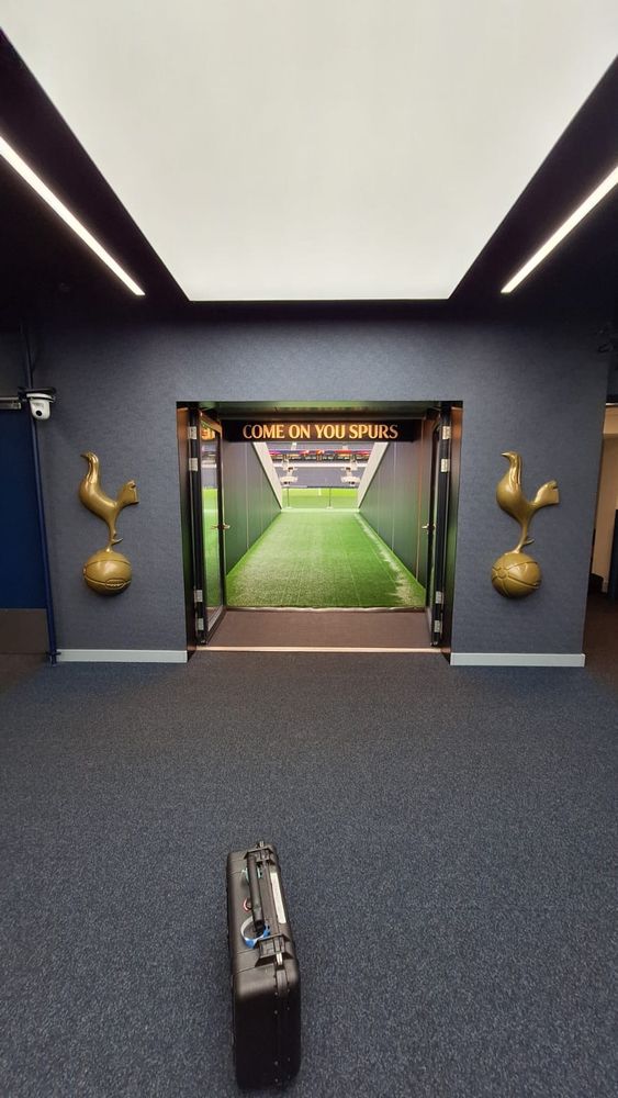 My kit case on the carpet in the foreground with a view of the Spurs tunnel and the walk out onto the pitch behind.