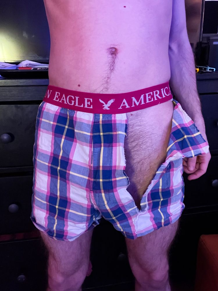 me in a pair of blue, white, pink and yellow plaid american eagle boxer shorts with a huge rip in them that goes from waistband almost all the way down to the end of the short 