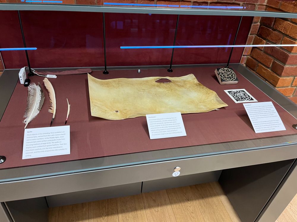 An exhibition case at Lambeth Palace Library containing items for the production of medieval books 