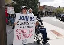 Julie Cohen protesting on a New Jersey street corner