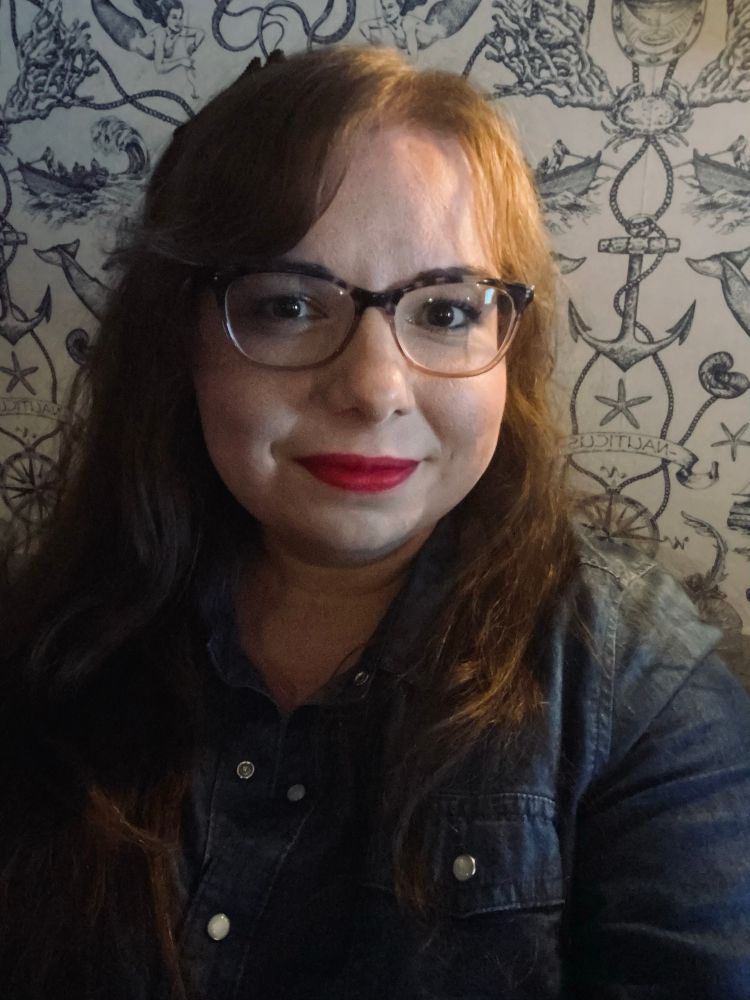 Portrait of me in front of some nautical wallpaper. 