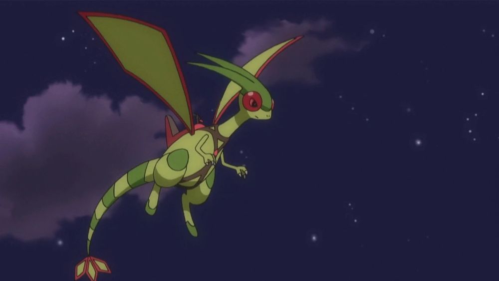 Flygon wearing a harness (i think?) flying in the night sky