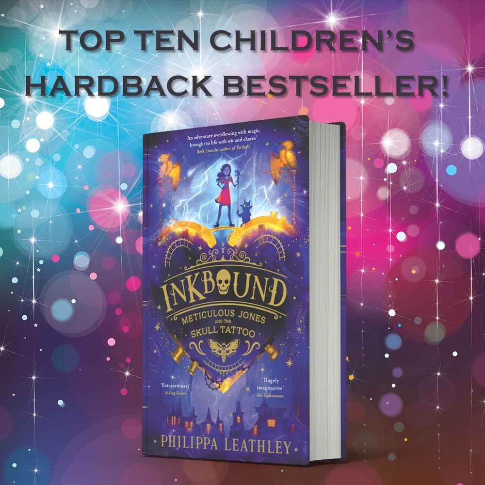 The book INKBOUND is placed on a background of pinks, blues and purples with flashes and sparkles to celebrate the news that it's a top ten children's hardback bestseller