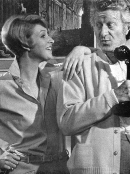 April Walker (5'8") stands with her arm resting on the shoulder of Jon Pertwee (6'2") in a black-and-white photo on the set of the 1968 play Oh Clarence!