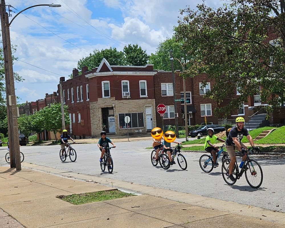 BWorks teacher Tom rounds a bend in Tower Grove South with a line of young riders following behind him on their way to the nearby park on the last day of the group's Earn-A-Bike class.