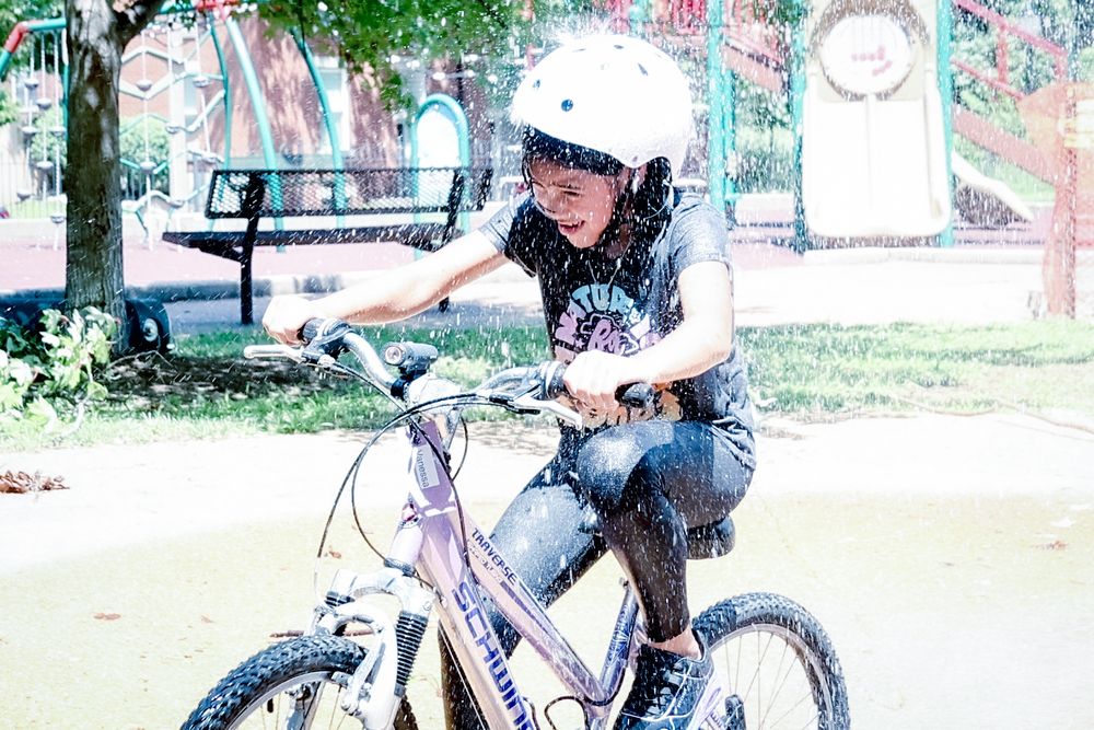 Another BWorks student takes a pass through spraying water at the fountain at Pontiac Park.