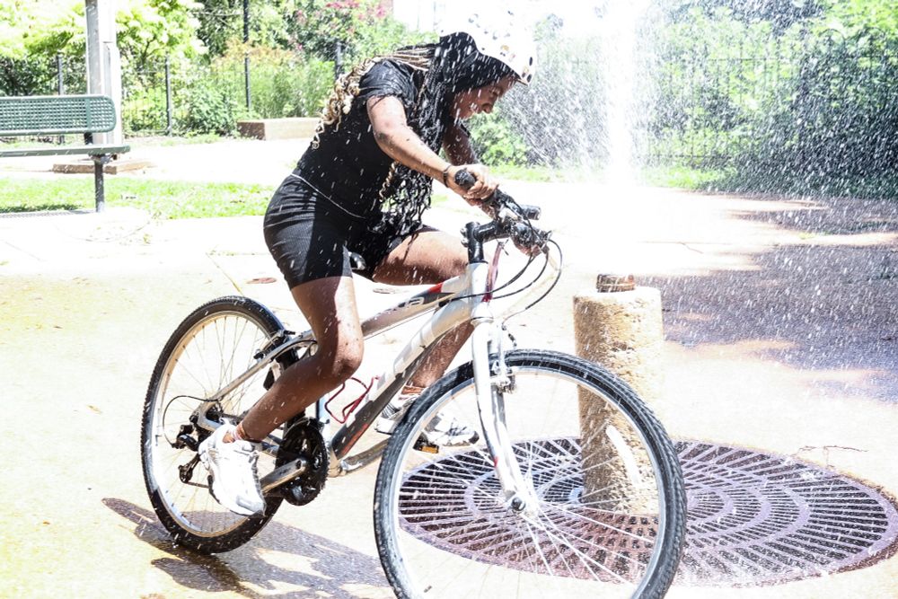 A BWorks Earn-A-Bike student pedals around a fountain in Soulard partway through Wednesday afternoon's graduation ride. 