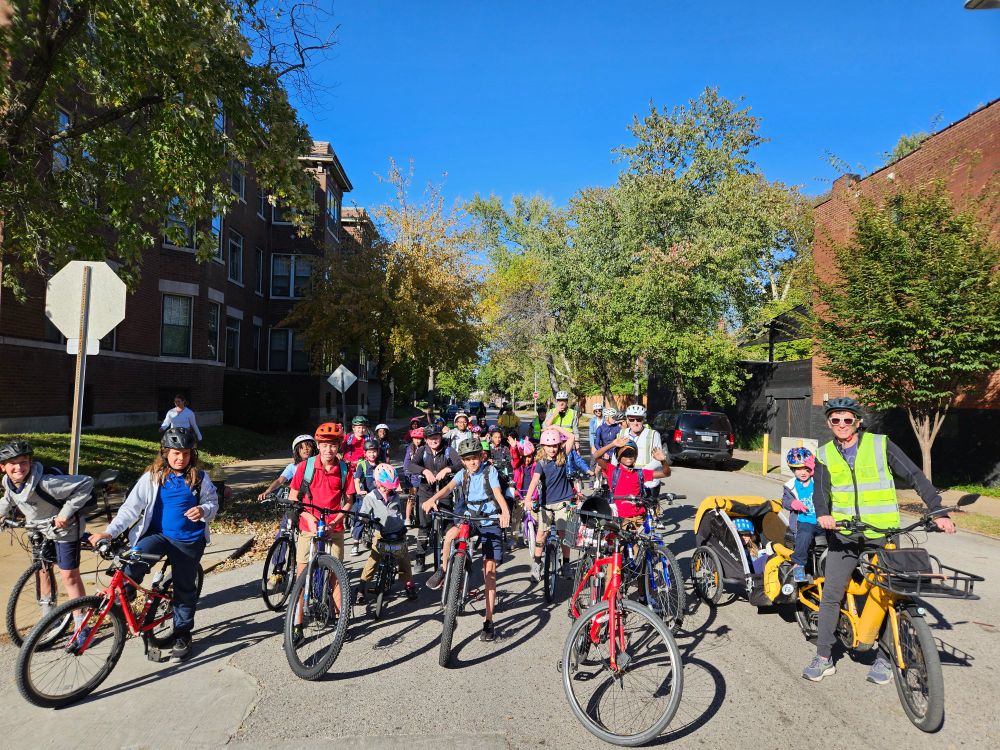 Speedy bike bus participants pause to allow everyone to queue up before crossing one of the busier intersections together Wednesday afternoon.