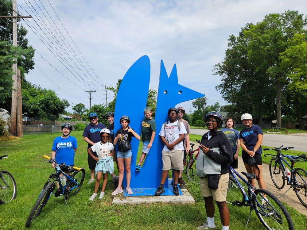 BWorks students and teachers pause to pose with Steele, one of the MCT Trail "critter" sculptures, in Granite City along the Nature Trail Saturday. 