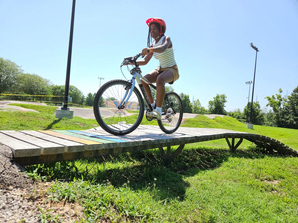 Balance and focus are key along the more-narrow-than-they-look wooden bridge passages at Kinetic Park, including this one that an Earn-A-Bike student is shown riding yesterday.