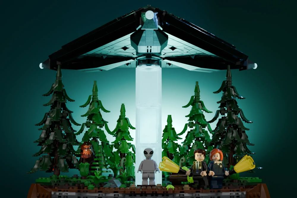 a closer shot of the forest scene, a grey alien is in a beam of light under the UFO and a Sasquatch, sadly not one with a massive rack, is hiding in the trees