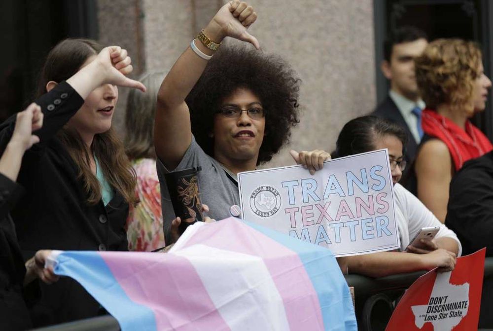 Nicki holding a sign that says TRANS TEXANS MATTER at the Capitol Rotunda during the SB7 hearing in 2017.