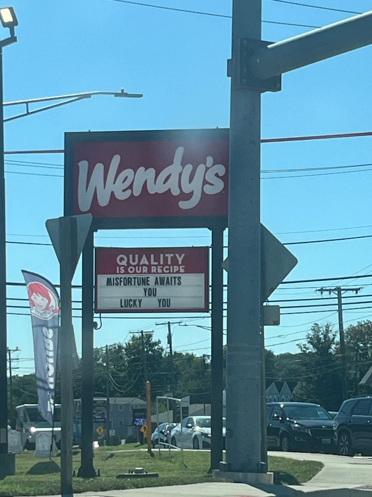 a Wendy’s that has a sign that says “Misfortune Awaits You. Lucky You”