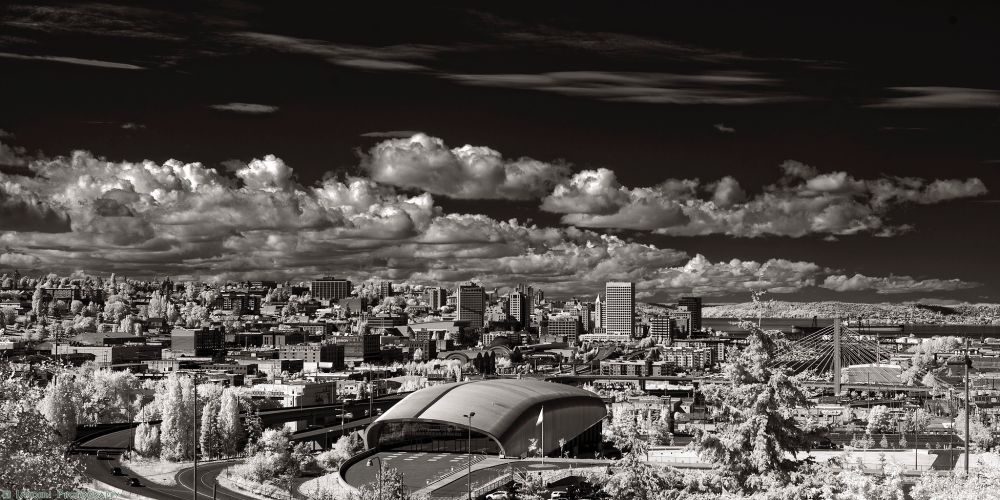 Black and white infrared wide shot of downtown Tacoma with Lemay Car Museum, and the cityscape spread out from edge to edge. 