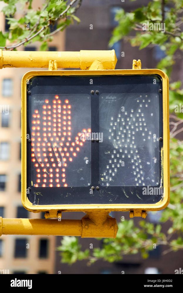 American pedestrian crossing sign - orange hand on the left (turned on) and white walking person on the right (turned off)