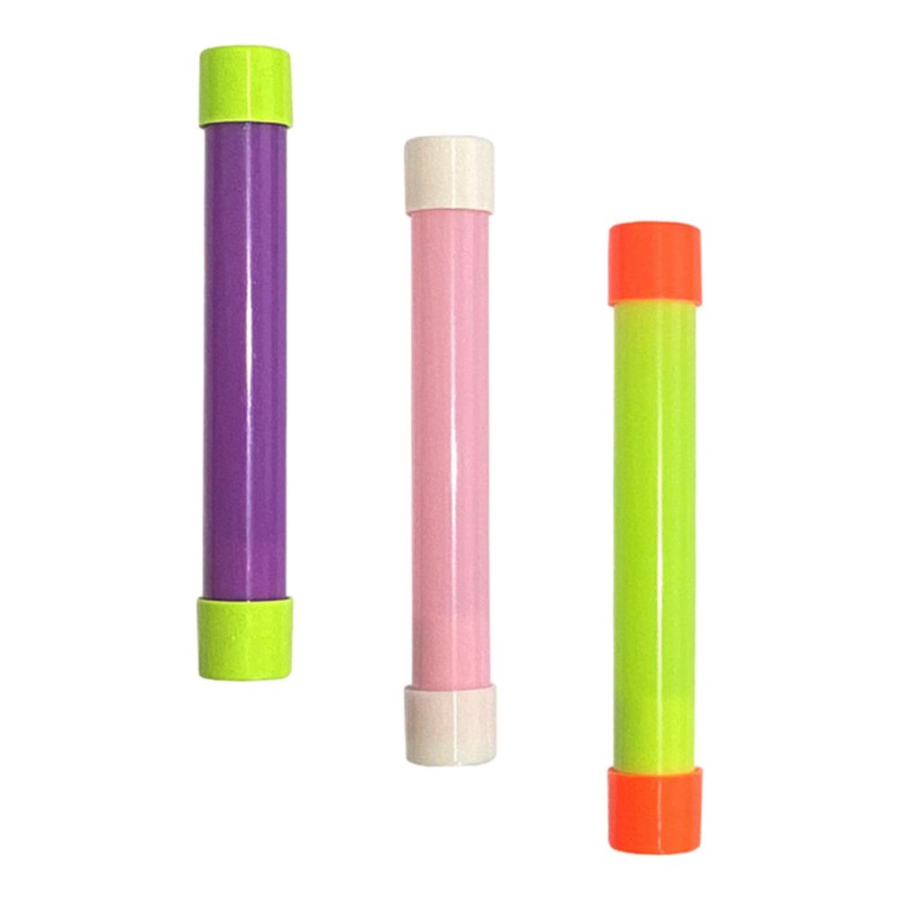 Three groan tubes in a staggered row. One is purple with green caps, one is pink with white caps. One is green with orange caps. They make a funny sound when you tip them.