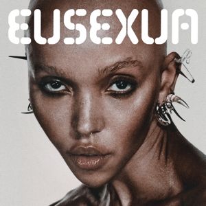 Album cover for FKA Twig's album called EUSEXUA.

A close up photograph of the artist is on a white background with white text at the top saying the album name.