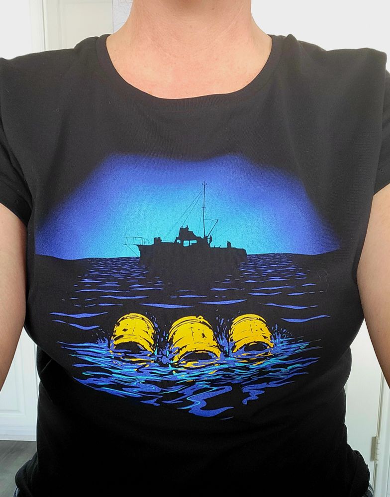 Selfie in a Last Exit to Nowhere shirt showing three floating yellow barrels and the Orca silhouette in the background 