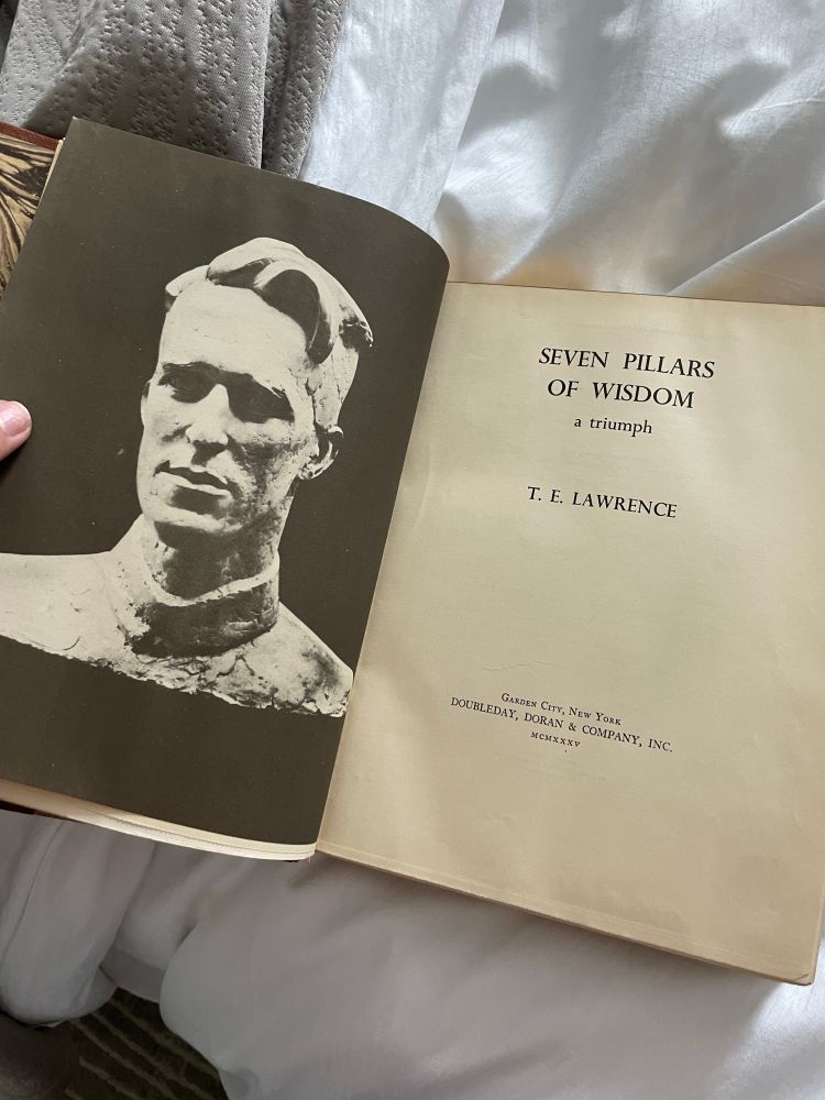 Inside title page of te Lawrence’s seven pillars of wisdom with a copy of his face 