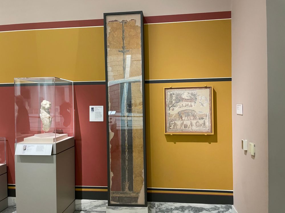 Roman wall section preserved and then the modern wall behind it is painted to match the design so you can see what it actually looked like!!