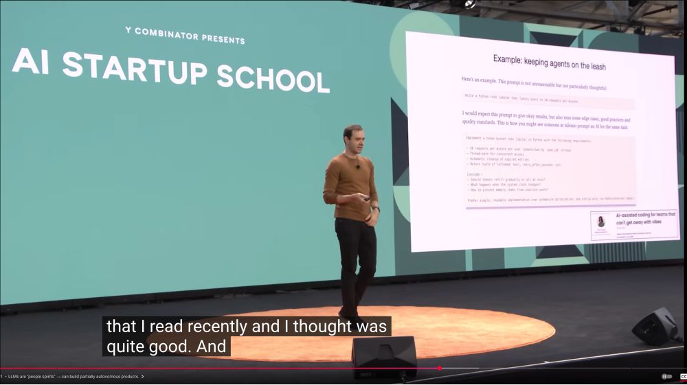 Andrej Karpathy on the YCombinator startup school stage talking about my AI-assisted coding blog post