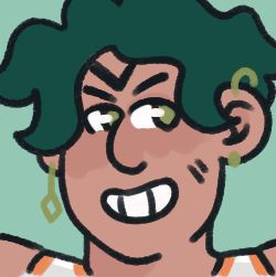 a closeup headshot of sacha. they have wavy, dark green dyed hair & lots of piercings (three ear piercings are visible in this picture)
they also have a V shaped tattoo on their forehead coming down from their hairline. they are grinning condifently