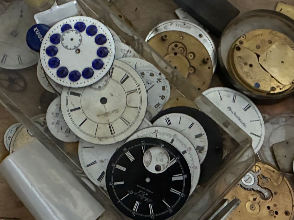 A box with several clock faces- just the faces, no arms or other parts