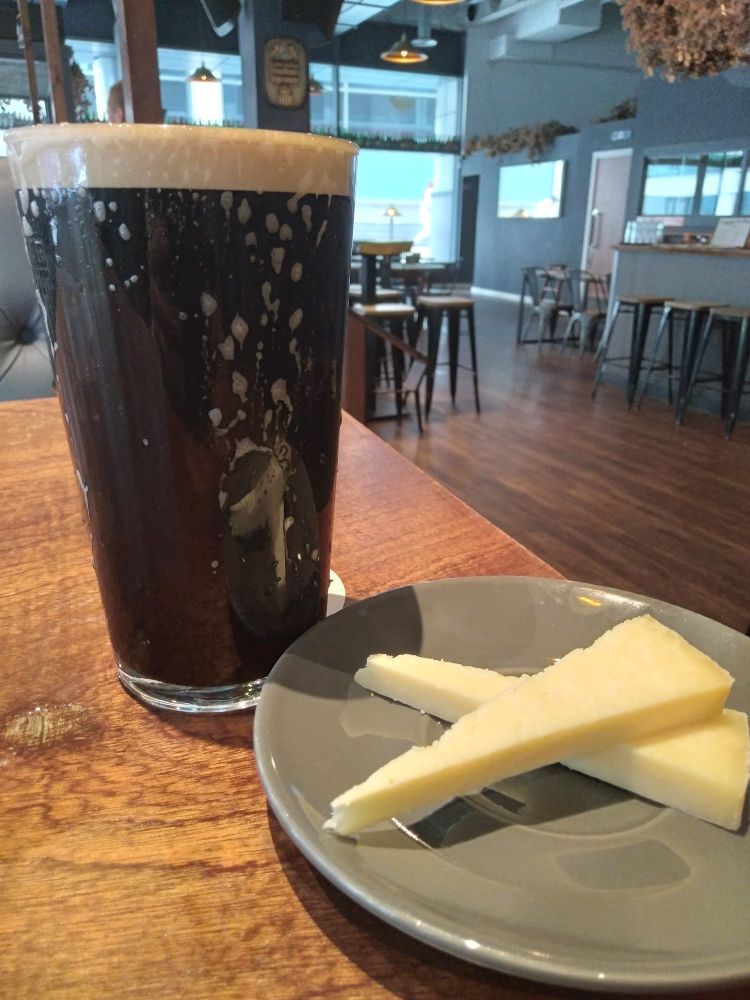 Pint of cask Kernel Running Porter and saucer with 2 wedges of Kirkhams Lancahire cheese. Delicious combination