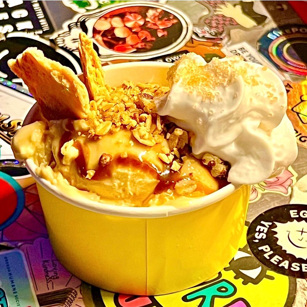 The Apple Pie Sundae consists of apple ice cream with apple pie filling and buttery pie crust crumbles, topped with an apple cider reduction, bourbon ginger caramel, brown sugar pecan streusel, CocoWhip, and more pie crust.
 
