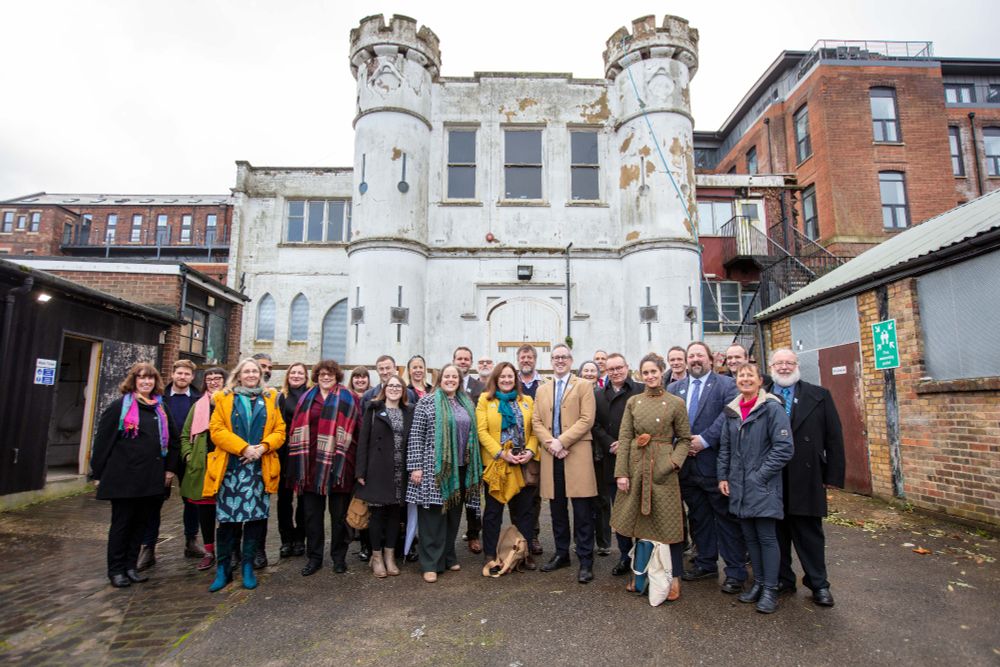 A large group of people smiling in front of the Waterworks in Medway, as they celebrate the announcement of the Heritage Development Trusts programme back in December 2023. Credit - Chris Gorman.