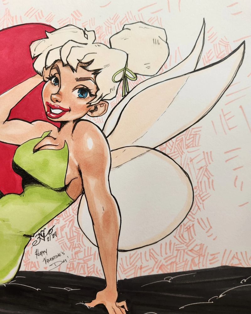 Close up of Tinker Bell smiling from the waist up. Her closest hand props her up  on a soft cushion as she lounges with a smile looking at the camera.