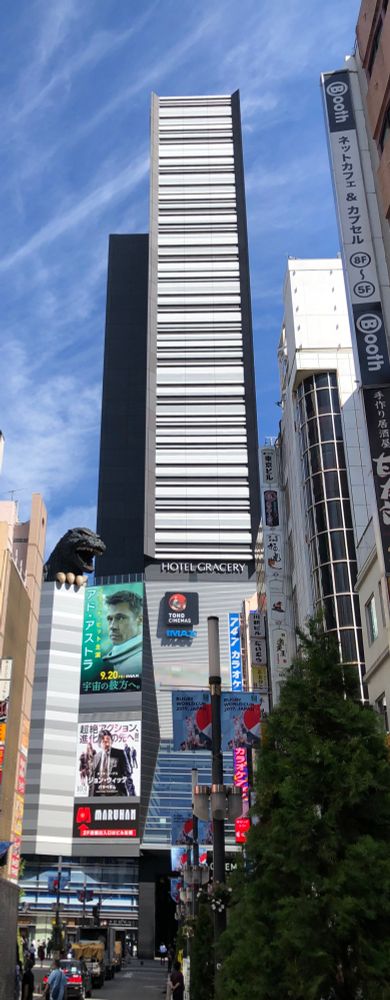 Hotel Gracery - Shinjuku Tokyo - looking very much like a giant barcode, with Gojira (Godzilla) peeking over a roof