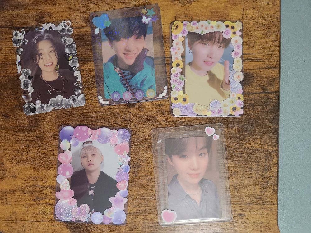 A selection of 5 Yoongi photocards in decorated top loaders