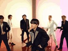 Yoongi dancing cutely at the front of the Butter "Hotter" Remix video with the members laughing and watching him in the background