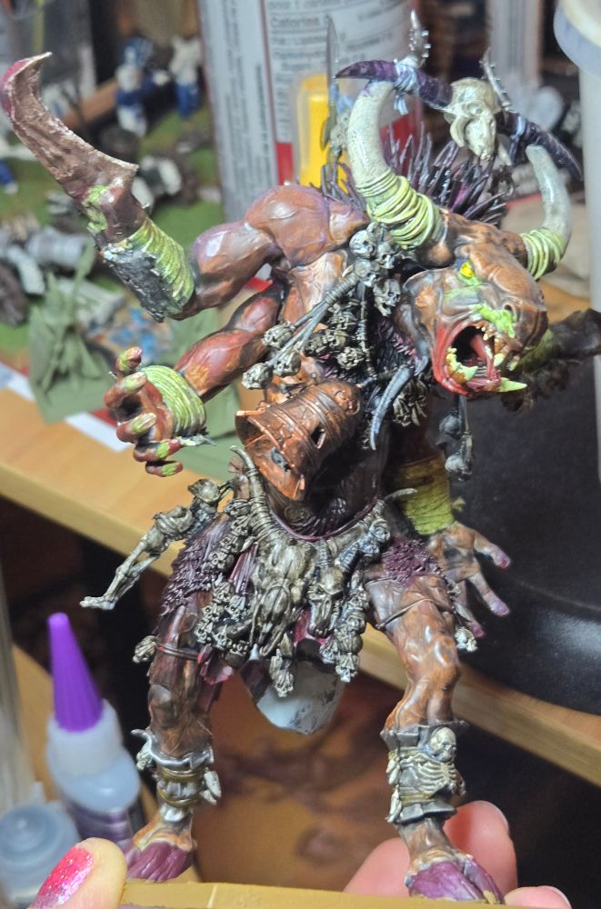 A mostly painted Ghorgon model. It has a lot of grime and muck all over it and has a lot of diseased mucus flowing from the eyes and nose.