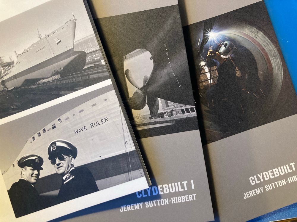 Photograph of three photography publications on a desk, showing Clydebuilt shipbuilding themed photographs. 