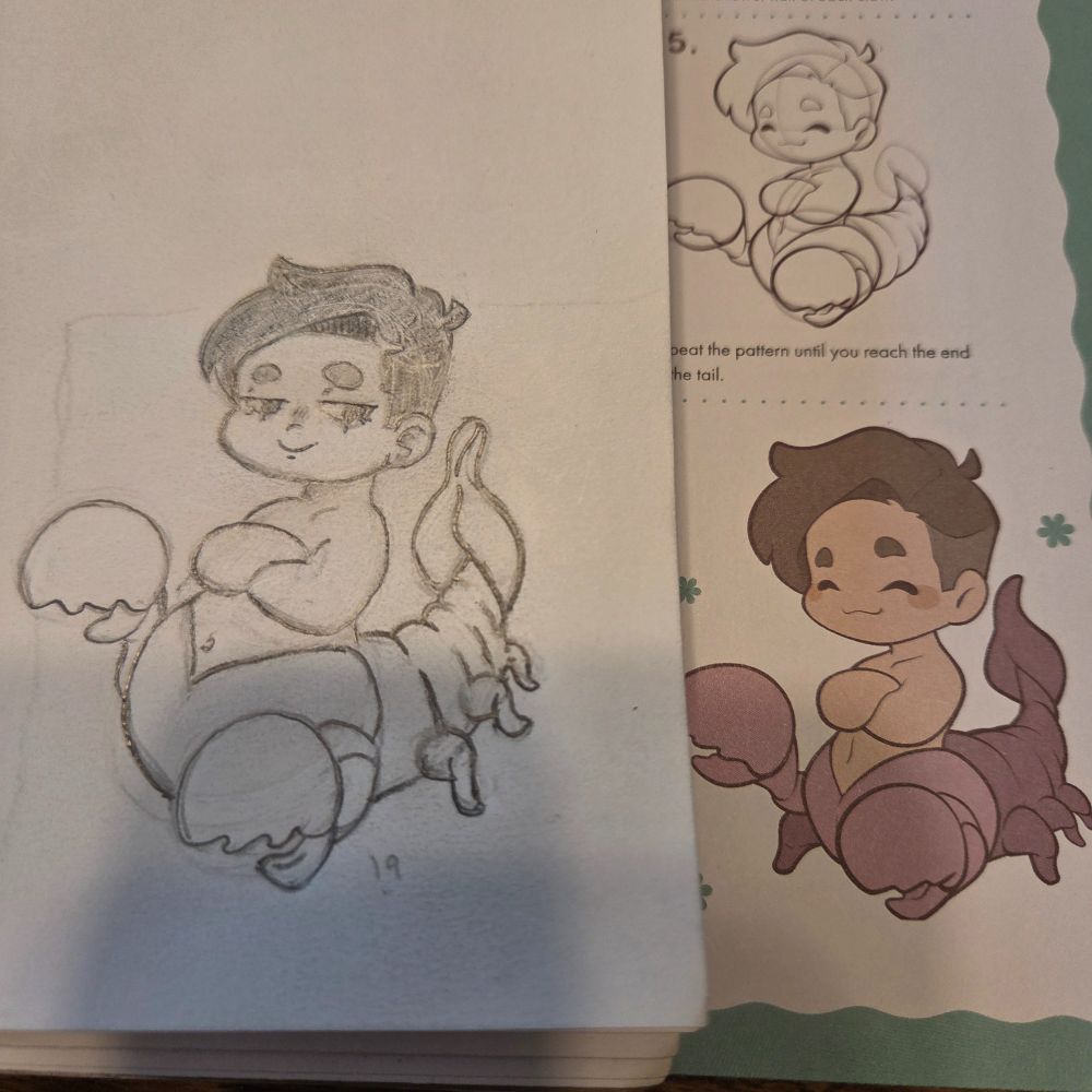 A drawing of an aquabuamelu, which is part human and part scorpion. The drawing is made of pencil and is sketched on white paper. An example of the creature is next to it within a book. It is all chibi style, made to look cute and friendly.